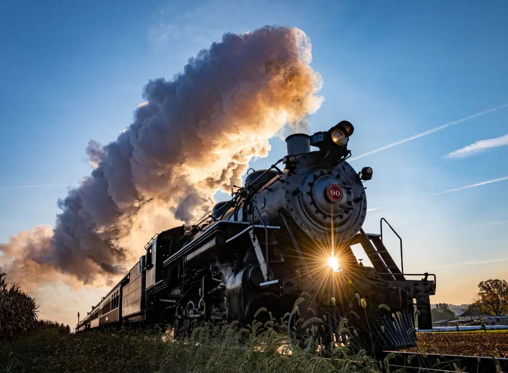 Train pluming smoke with a sunray