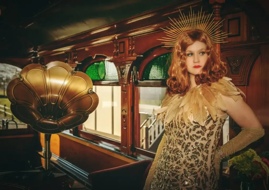 An Actress standing in a train car room
